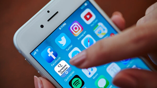 A person uses their smartphone to launch the symptom checking app