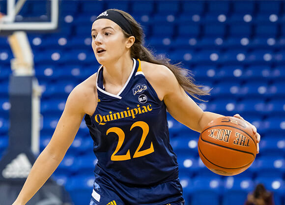 DeWees dribbles the ball on the court.