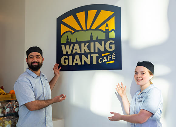 Students stand in front of Waking Giant Cafe