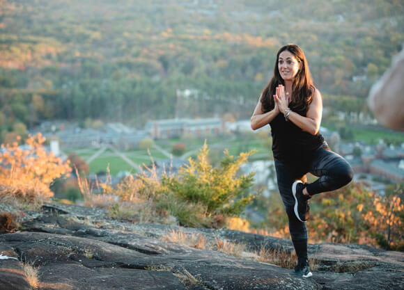 Tami Reilly instructing yoga group on sleeping giant