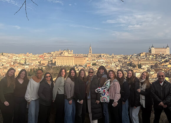 Group of students and faculty standing outside the city walls of Toledo, Spain
