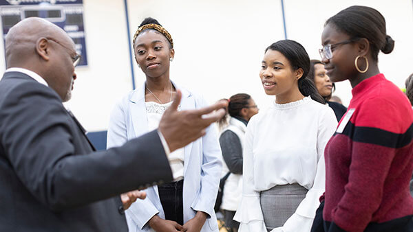 Students talk with a visiting speaker at a Black History Month event in Burt Kahn Court
