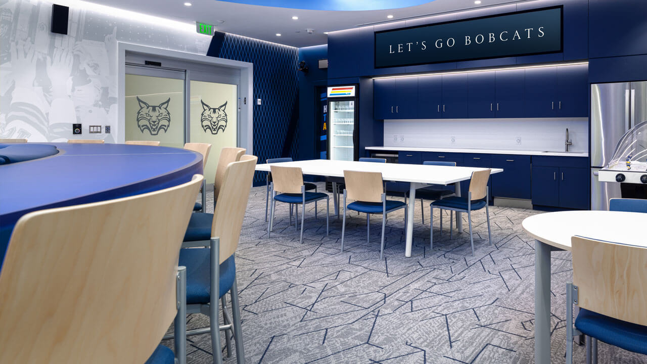 Chairs and tables inside the women's ice hockey locker room.