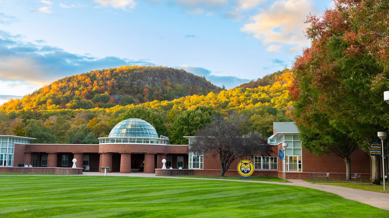 Sleeping Giant State Park and a blue sky rise above the Quinnipiac quad