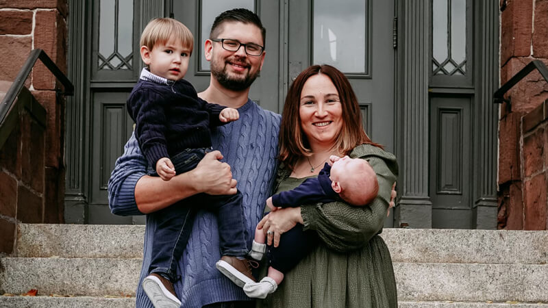 The McCarthy family smiles from stone steps