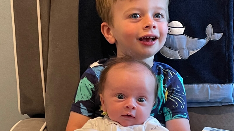 Connor DeSimone is held by big brother Jayden in an armchair