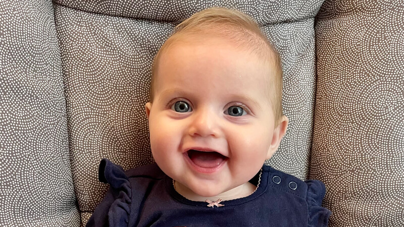 Hailey Pearl Sarin flashes a wide-mouthed, toothless grin