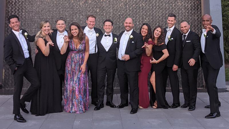 Wedding guests smile and pose with their arms in Bobcat swipes