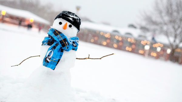 Snowman with Quinnipiac scarf and hat outside the student center