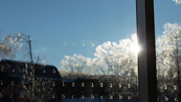 Icy trees reflect on the windows of the Quinnipiac library