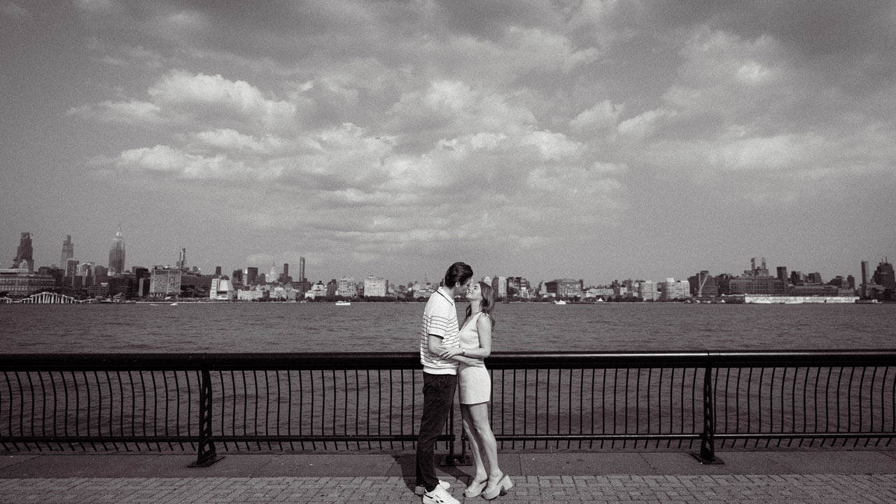 Olivia Schueller and Chris Dacey share a kiss in a black and white vintage inspired photo