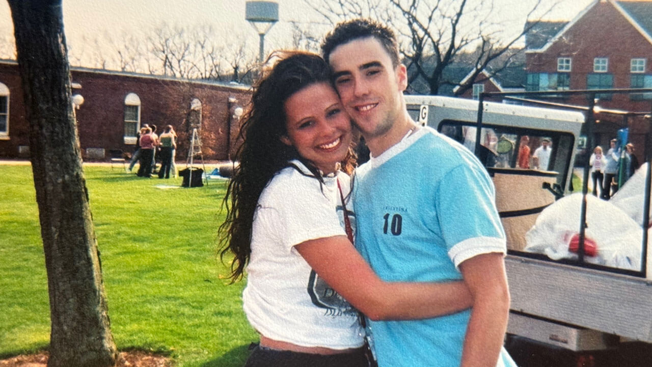 Mara and Joe Almada hug each other on the quad