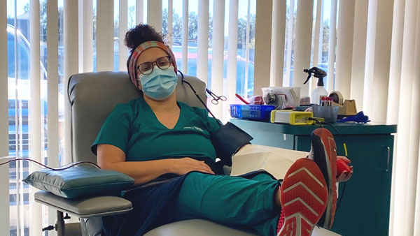 Chinnici sits in a hospital room donating blood plasma