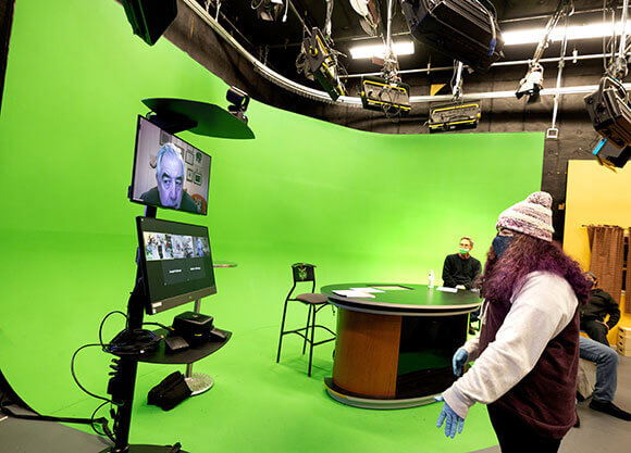 A student speaks to a guest speaker via zoom cart