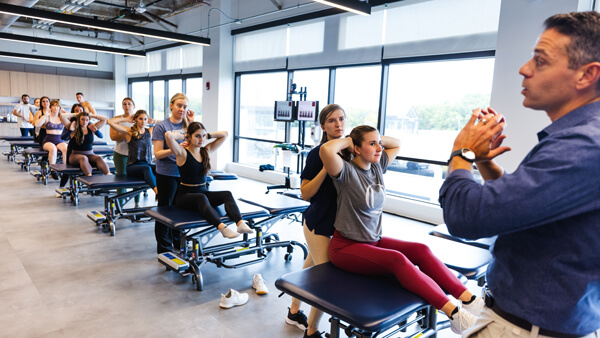 Professor instructs a class of occupational physical therapists.