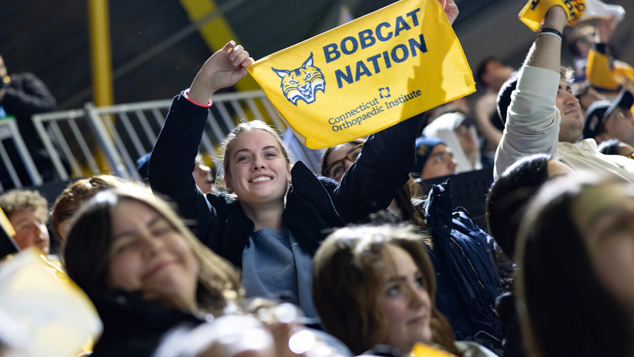 Person holding a "Bobcat Nation" sign