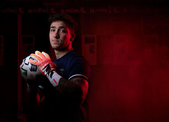 Headshot of Jared Mazzola with a soccer ball