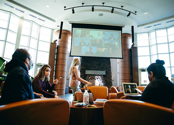 Students watch the State of the QUnion in the Piazza