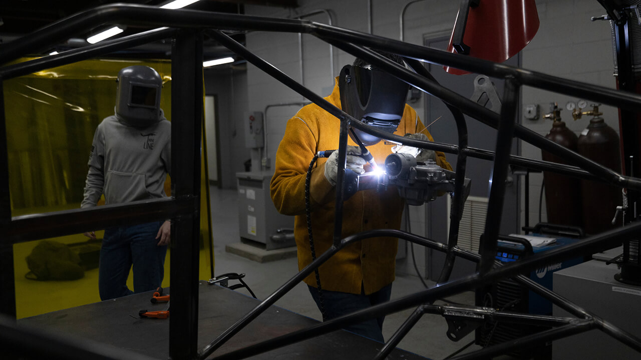 Engineering students build a car.