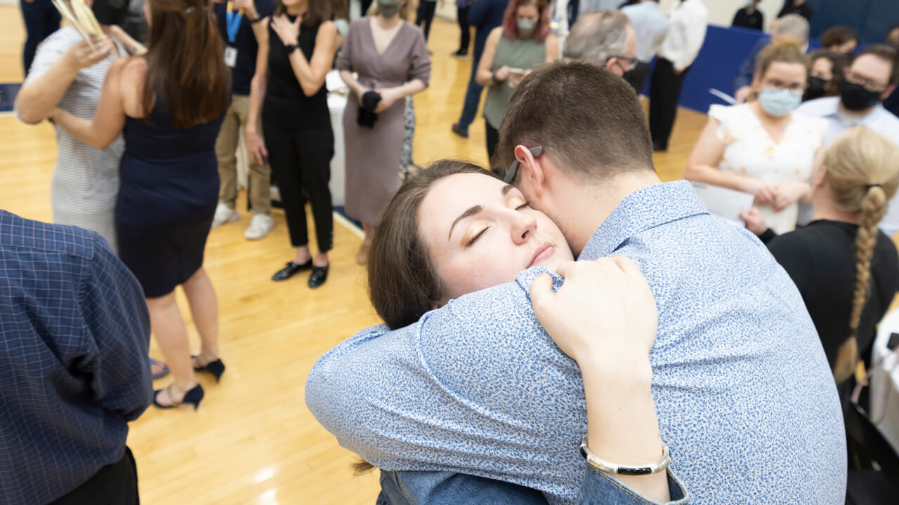 People embrace during the Match Day celebration