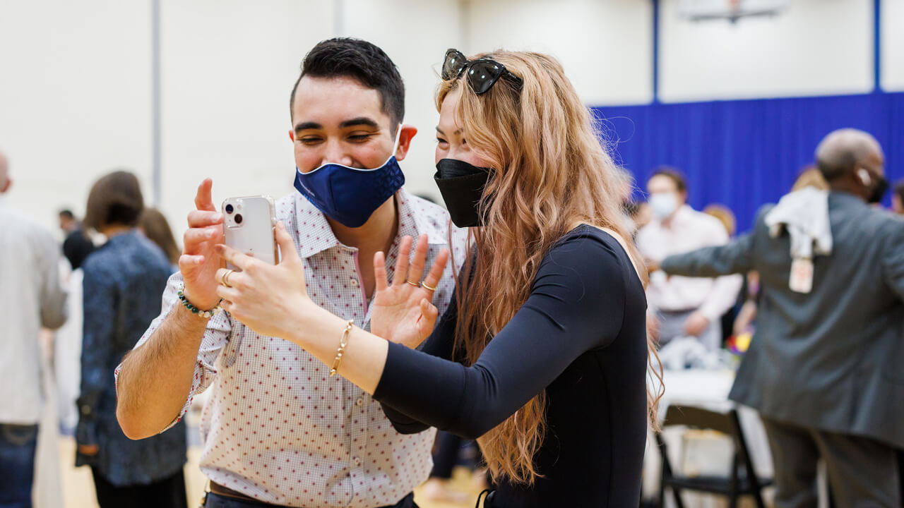 A medical student waves as she speaks with someone on a video call during Match Day