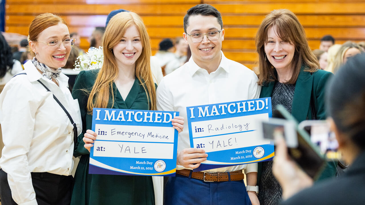 Ava Vause and Eldar Sorkin pose with their "I Matched" signs with two loved ones