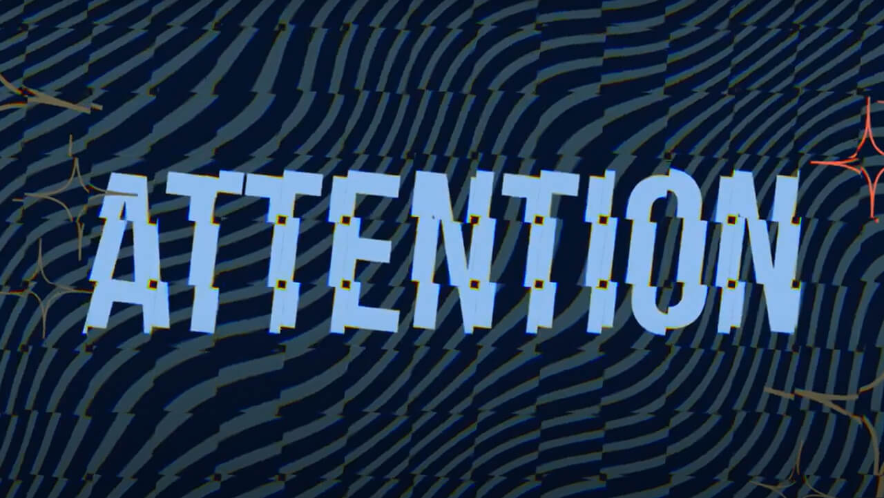 A distorted graphic that says "Attention", plays video
