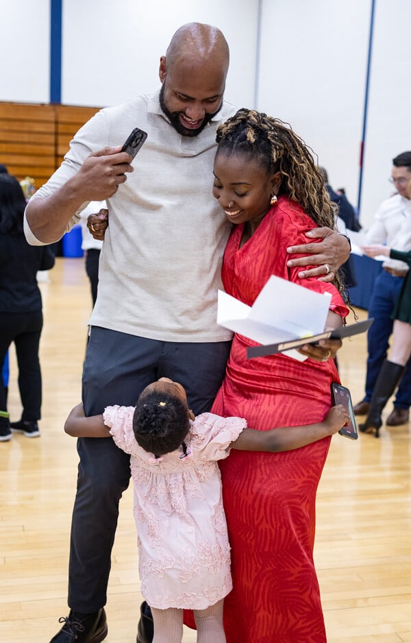 Kizzi Belfon receives hugs from her husband and three-year old daughter