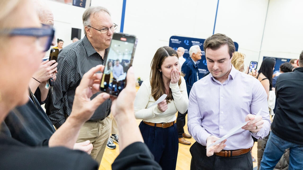 School of Medicine student shows his placement to a shocked loved one