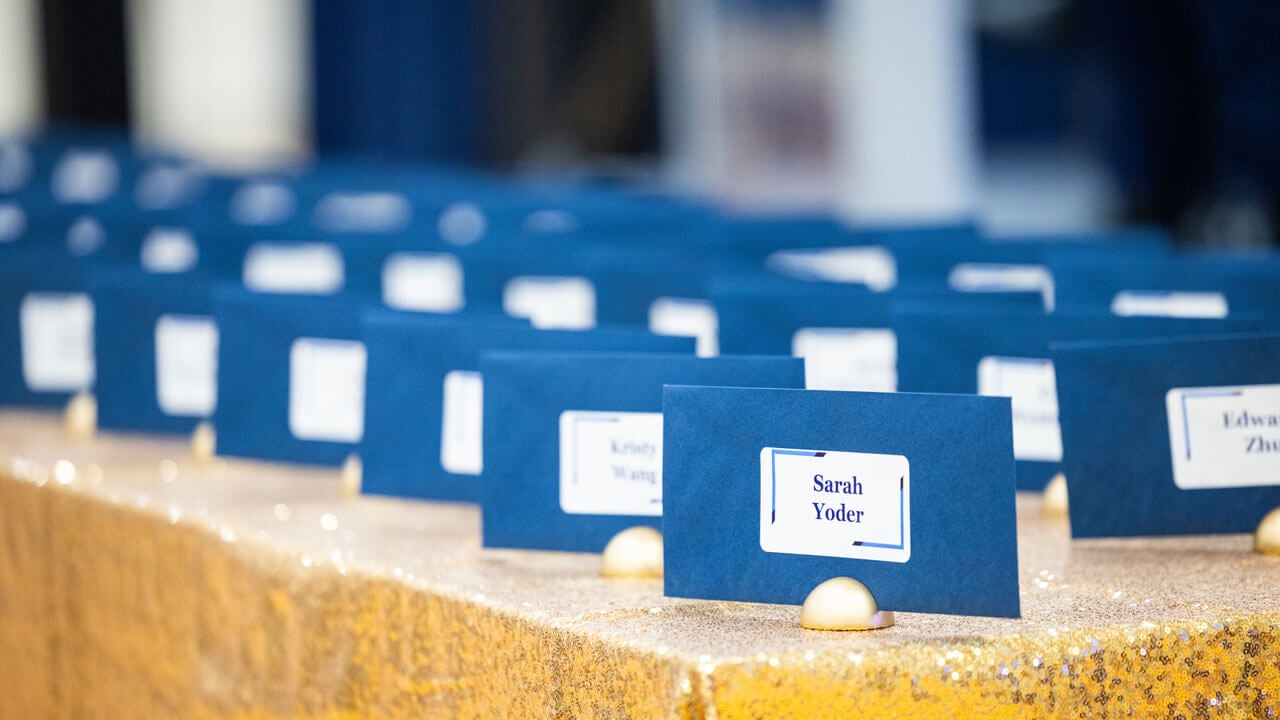 Blue cards with School of Medicine students lined up on a table