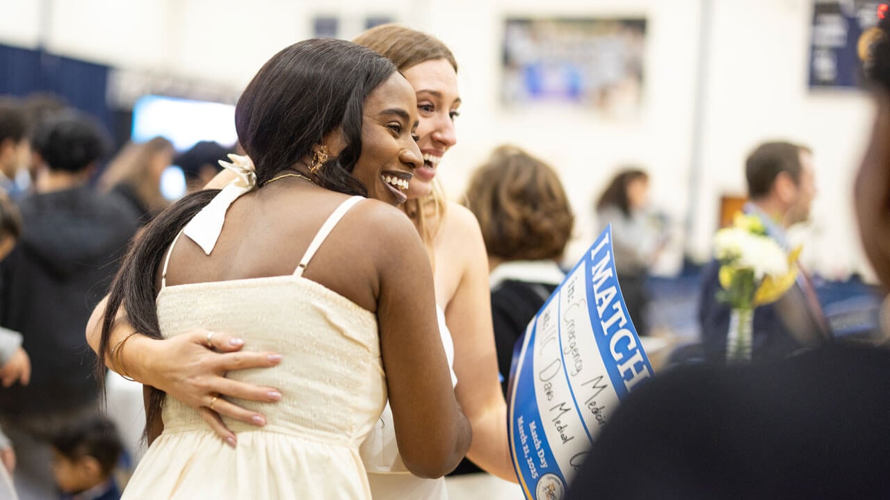 Two students hug each other at Match Day 2025