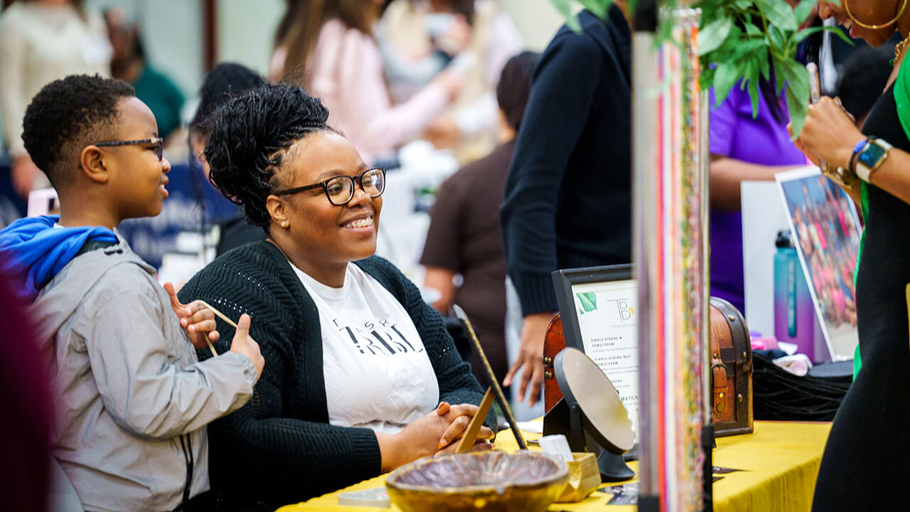 Small business owner smiling at a customer