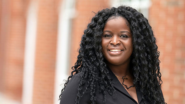 Caurice Wynter, MD `22 smiles in a portrait.