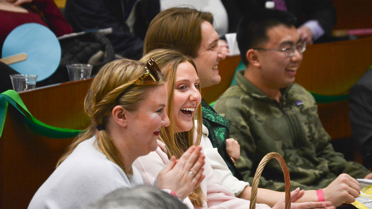 Audience smiles at PILP auction.