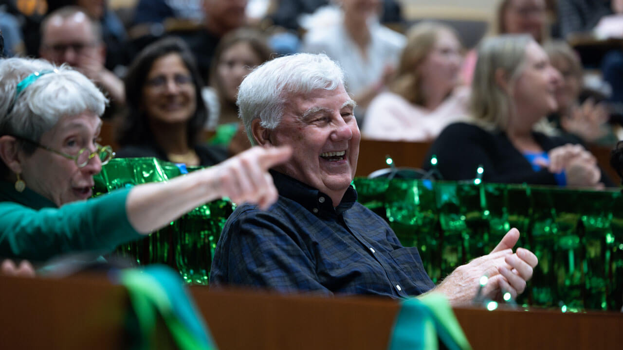 Audience participant in the auction by raising their hands.