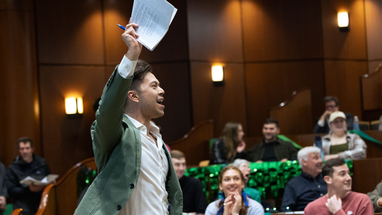 Participants raise their hands at the PILP auction.