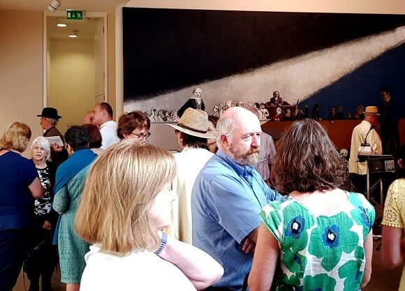 People speak to friends at the opening.