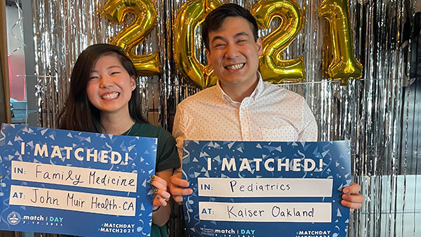 Students celebrate Match Day in front of balloons