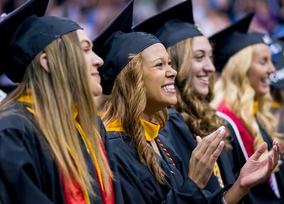 Graduates clap during Commencement.
