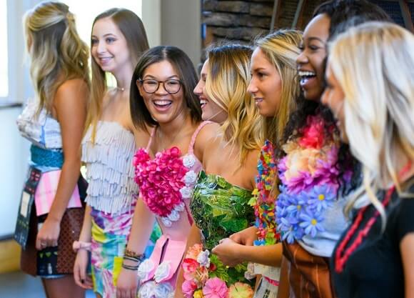 A row of students wearing clothes made from recycled materials.
