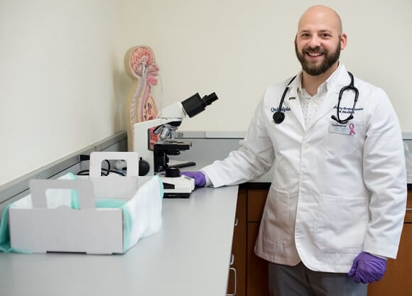 Anthony Boguslawski, MHS 18, stands by a microscope.
