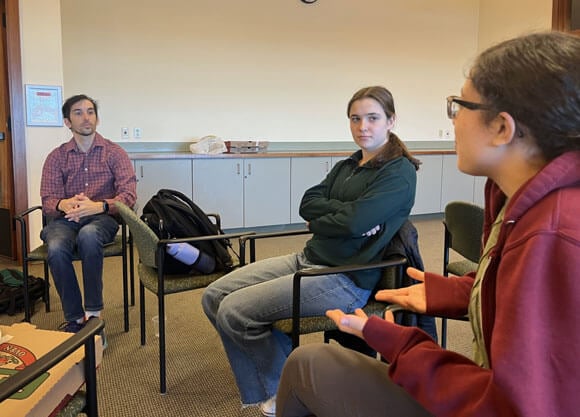 Faculty and staff converse with each other.
