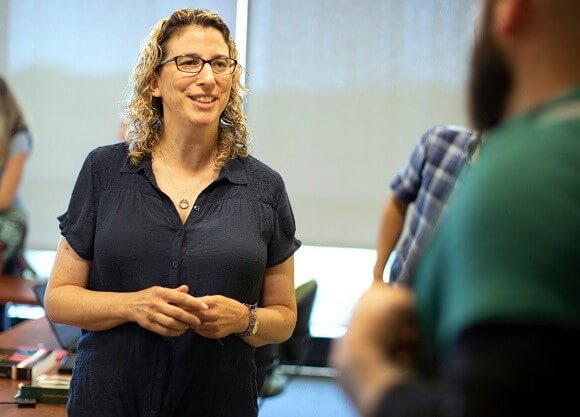 Woman talks to a group of people