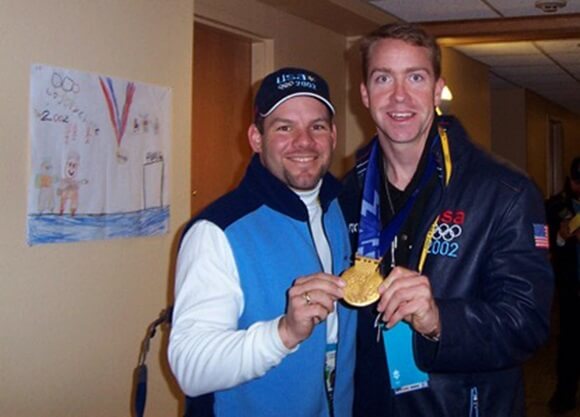 Smith smiles with an Olympic medal.