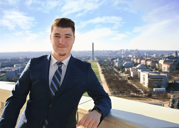 Photo of alumnus, Nicholas Martin, with the Washington Monument in the background.