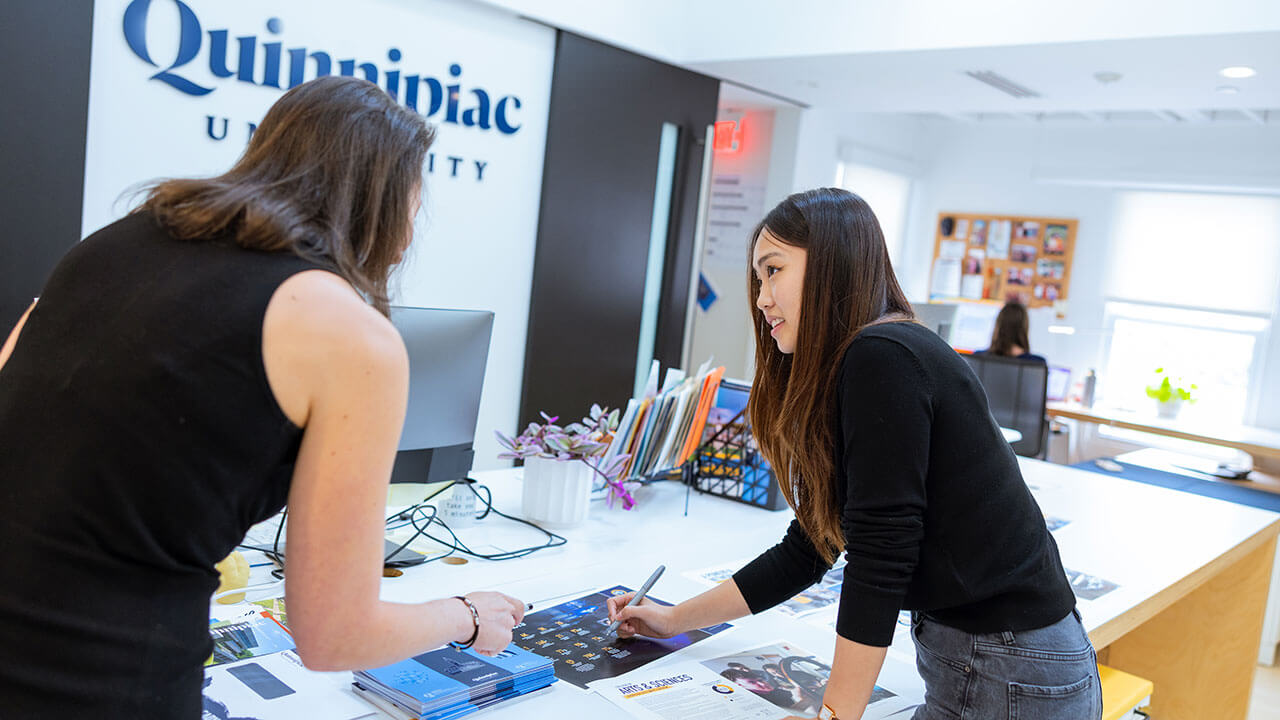 Student working with faculty on digital graphic concepts