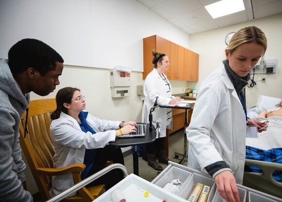 Nursing students practicing on live simulation manikin