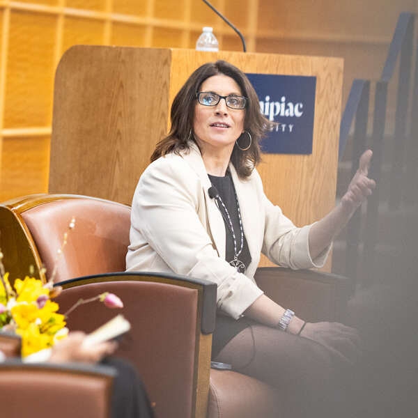 Sarah Harris sits in an arm chair in a Quinnipiac auditorium during the critical conversation