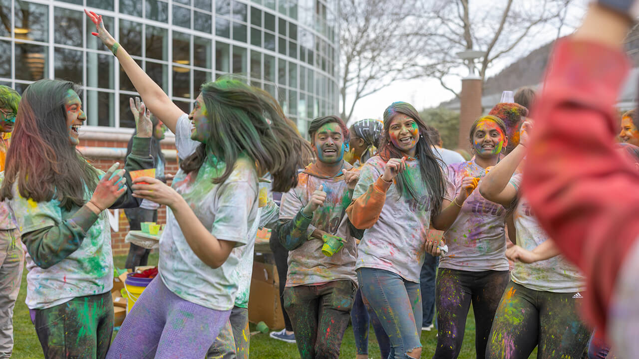 Students dancing together at Holi celebration