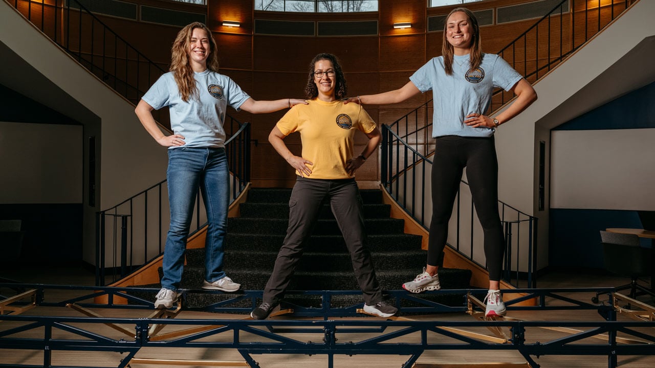 Faculty adviser and co-captains pose on the bridge